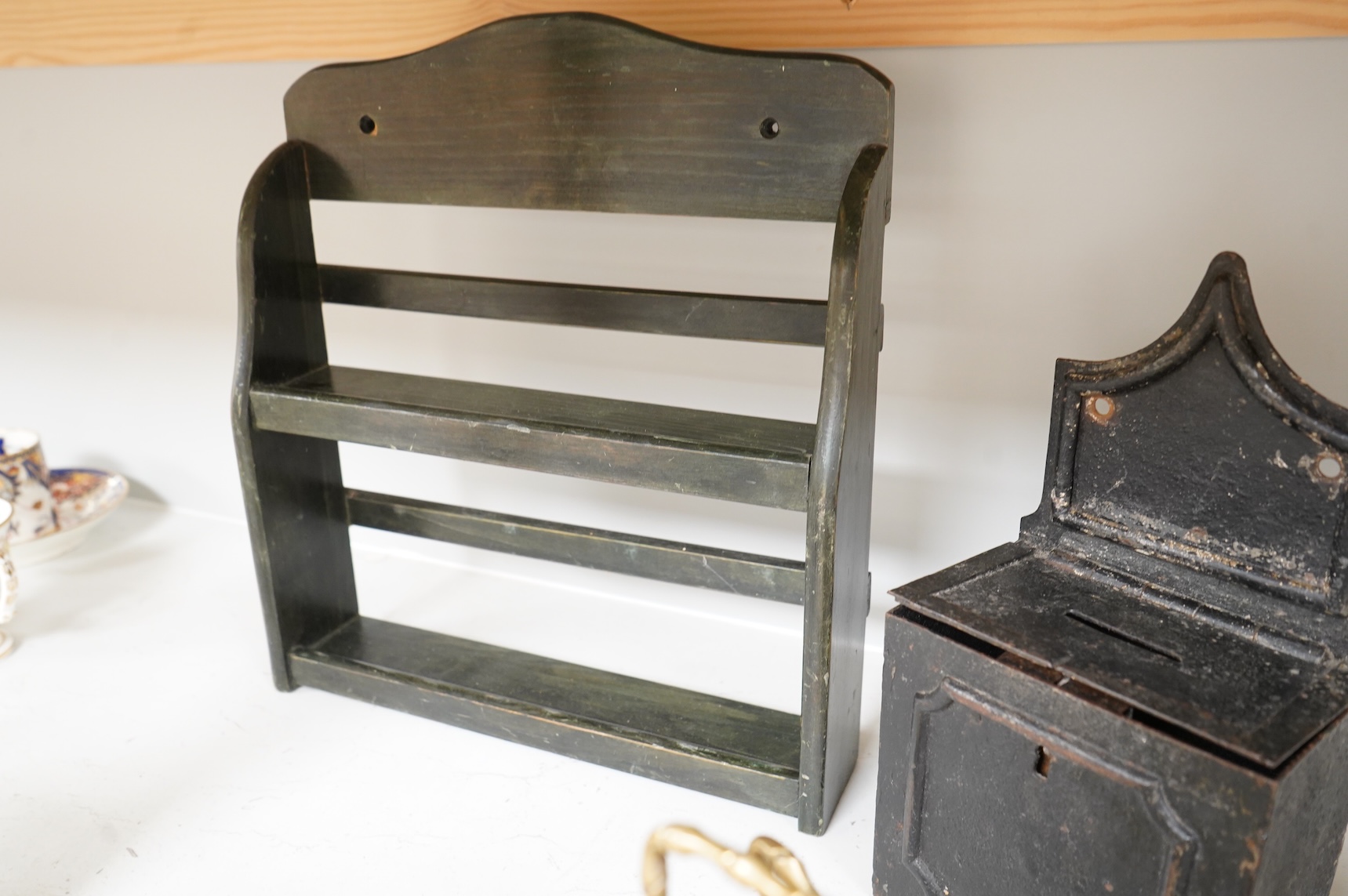 Sundry items to include an iron money box, brass letter rack, horse door stop and a 19th century oak carving, largest 32cm high